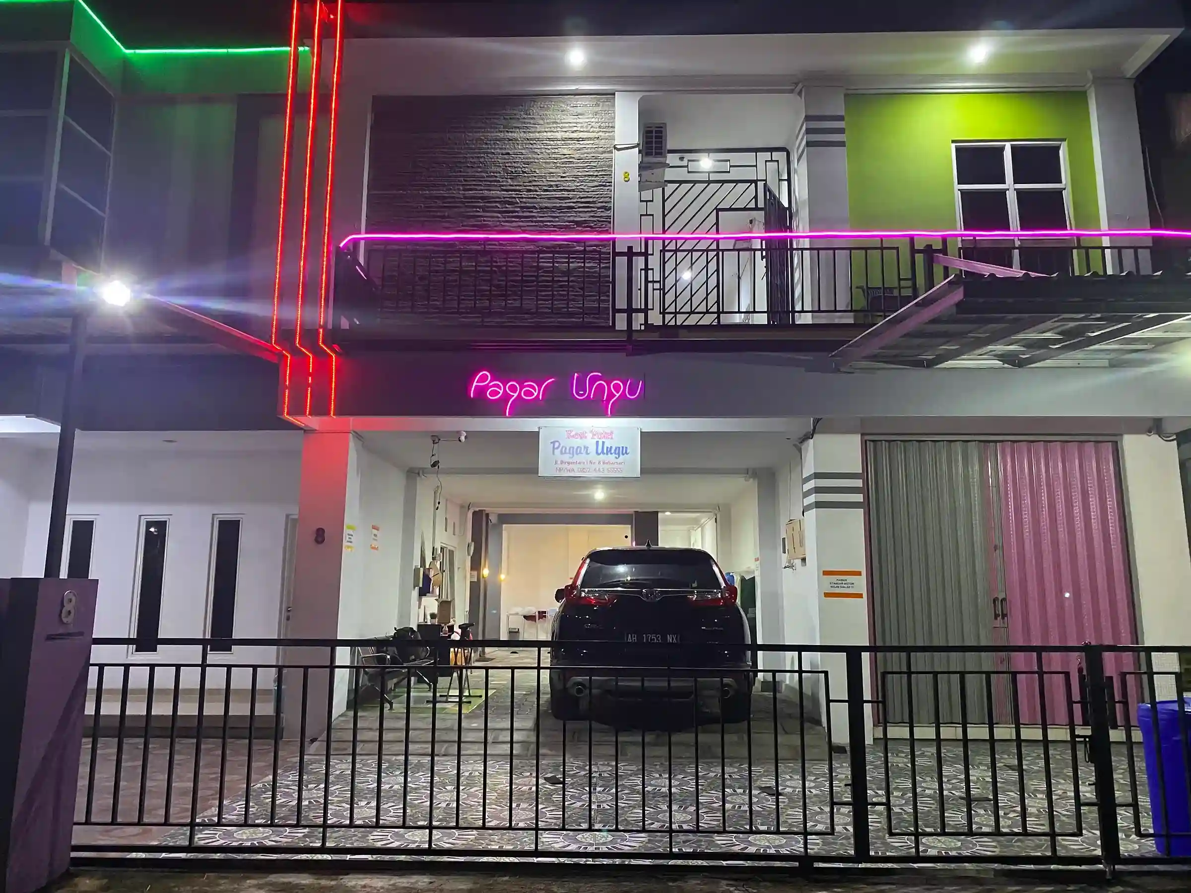 Tampak depan Kost Putri Pagar Ungu di malam hari